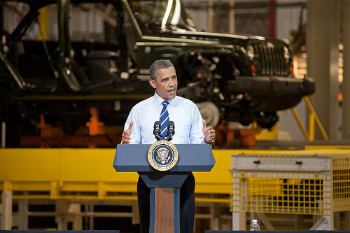 Obama speaking at an auto factory. At the large size, Obama is easily recognizable.